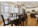Bright dining room with hardwood floors, large windows, and chandelier adjacent to kitchen at 4404 Old Georgetown Trl, Atlanta, GA 30338