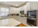 Well-appointed kitchen with stainless steel appliances, granite countertops, and custom cabinetry at 4404 Old Georgetown Trl, Atlanta, GA 30338