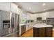 Updated kitchen with stainless steel appliances, white cabinets, and granite countertops at 4404 Old Georgetown Trl, Atlanta, GA 30338