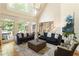 Spacious living room featuring soaring ceilings, large windows, and comfortable sofas at 4404 Old Georgetown Trl, Atlanta, GA 30338