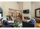 Comfortable living room featuring a fireplace and open access to the dining area at 4404 Old Georgetown Trl, Atlanta, GA 30338