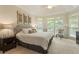 Light-filled main bedroom featuring large windows, tray ceilings, and neutral decor at 4404 Old Georgetown Trl, Atlanta, GA 30338