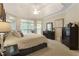 Light-filled main bedroom featuring large windows, tray ceilings, and neutral decor at 4404 Old Georgetown Trl, Atlanta, GA 30338