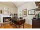 Cozy home office featuring a fireplace, hardwood floors, and built-in shelving at 4404 Old Georgetown Trl, Atlanta, GA 30338