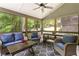 Relaxing screened-in patio with comfortable seating and ceiling fan with wooded views at 4404 Old Georgetown Trl, Atlanta, GA 30338
