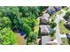 Birds-eye view of a well-maintained house nearby a small pond and lush trees at 4885 Maristone Landing Way, Cumming, GA 30040