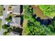 Top-down aerial view of a residence next to a pond and featuring a backyard wooden deck at 4885 Maristone Landing Way, Cumming, GA 30040