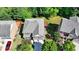 Aerial view of a well-maintained home with a gray roof, a deck, and a lush green lawn at 4885 Maristone Landing Way, Cumming, GA 30040