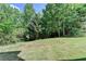 Lush backyard space with mature trees and a gently sloping lawn at 4885 Maristone Landing Way, Cumming, GA 30040