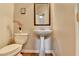 Half bathroom features pedestal sink, decorative mirror, and charming wall decor at 4885 Maristone Landing Way, Cumming, GA 30040
