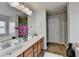 Bathroom featuring double sinks, tile floor, separate shower, large tub, and lots of counter space at 4885 Maristone Landing Way, Cumming, GA 30040