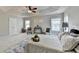 Bright bedroom featuring a tray ceiling, ceiling fan, carpet, neutral color palette, and decor at 4885 Maristone Landing Way, Cumming, GA 30040