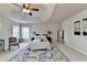Comfortable bedroom featuring a tray ceiling, ceiling fan, area rug, and lots of natural light at 4885 Maristone Landing Way, Cumming, GA 30040