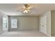 Bright bedroom featuring neutral walls, plush carpeting, a ceiling fan, and a large window at 4885 Maristone Landing Way, Cumming, GA 30040
