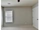 Bright bedroom featuring neutral walls, plush carpeting, and a window at 4885 Maristone Landing Way, Cumming, GA 30040