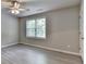 Bedroom showcasing wood-look flooring, a window, and a ceiling fan at 4885 Maristone Landing Way, Cumming, GA 30040