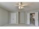 Bright bedroom featuring neutral walls, plush carpeting, a ceiling fan, and doors at 4885 Maristone Landing Way, Cumming, GA 30040