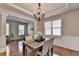 Bright dining room with natural light, hardwood floors, and stylish chandelier at 4885 Maristone Landing Way, Cumming, GA 30040