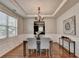 Dining room with hardwood floors, tray ceiling, and wainscoting detail at 4885 Maristone Landing Way, Cumming, GA 30040