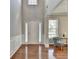 Bright foyer with hardwood floors, neutral walls, and a view of the staircase at 4885 Maristone Landing Way, Cumming, GA 30040