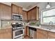 Modern kitchen showcasing stainless steel appliances, granite countertops, and stylish backsplash at 4885 Maristone Landing Way, Cumming, GA 30040