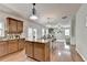 Open kitchen with island, hardwood floors, and seamlessly connected living area at 4885 Maristone Landing Way, Cumming, GA 30040