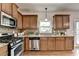 Functional kitchen featuring stainless steel appliances, granite countertops, and ample cabinet space at 4885 Maristone Landing Way, Cumming, GA 30040