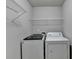 The laundry room featuring a modern washing machine and dryer at 4885 Maristone Landing Way, Cumming, GA 30040