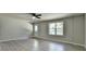 Spacious living room with vinyl floors, a ceiling fan, and a back door at 4885 Maristone Landing Way, Cumming, GA 30040