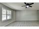 A bright and spacious living room with wood-look flooring and a large window at 4885 Maristone Landing Way, Cumming, GA 30040