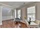 Cozy living room with hardwood floors, wainscoting, and natural light from large windows at 4885 Maristone Landing Way, Cumming, GA 30040