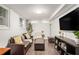 Basement living room features a comfortable couch, ottoman, and large screen TV at 677 Holmes Nw St, Atlanta, GA 30318