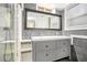 Bathroom with modern vanity, double sinks, and shower with stylish tiling at 677 Holmes Nw St, Atlanta, GA 30318