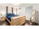 Simple bedroom with stylish natural wood drawers, bedside tables, and dark blue bed at 677 Holmes Nw St, Atlanta, GA 30318