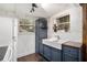 White appliances, subway tile backsplash, and deep blue cabinets provide a modern kitchen aesthetic at 677 Holmes Nw St, Atlanta, GA 30318
