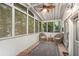 Relaxing screened porch with wicker furniture, decorative rug, and wooded views at 677 Holmes Nw St, Atlanta, GA 30318