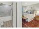 Inviting bedroom with rug, bench, and bathroom featuring tiled shower and decorative floor at 157 Maribeau Nw Sq, Atlanta, GA 30327