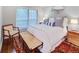 Comfortable bedroom with a bright window, chair, patterned rug and tasteful decor at 157 Maribeau Nw Sq, Atlanta, GA 30327