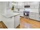 Bright and modern kitchen featuring stainless steel appliances, white cabinets and island at 157 Maribeau Nw Sq, Atlanta, GA 30327