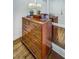 Close up of a lovely wooden dresser with hardwood floors and attractive decor at 157 Maribeau Nw Sq, Atlanta, GA 30327
