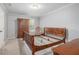 Bright bedroom featuring light gray walls, carpeted flooring, and a wooden bed frame at 2105 Country Park Se Dr, Smyrna, GA 30080