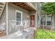 Exterior view of a two-story home with a welcoming front porch and well-maintained landscaping at 2105 Country Park Se Dr, Smyrna, GA 30080