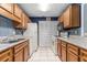 Classic galley kitchen with tiled backsplash, wooden cabinets, and essential appliances at 2105 Country Park Se Dr, Smyrna, GA 30080