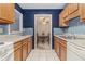 Galley kitchen featuring tiled backsplash, wooden cabinetry, and view of dining area at 2105 Country Park Se Dr, Smyrna, GA 30080