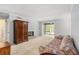 Open concept living room with fireplace, large armoire, and an adjoining sunroom at 2105 Country Park Se Dr, Smyrna, GA 30080