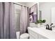 Bathroom with white vanity, modern fixtures, a gray shower curtain, and stylish artwork at 2749 Porches Ln, Dacula, GA 30019