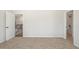 Bright bedroom featuring neutral carpet, a door to the hallway, and an ensuite bathroom entrance at 2749 Porches Ln, Dacula, GA 30019