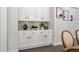 Bright butler's pantry featuring white cabinetry, neutral backsplash, and modern hardware at 2749 Porches Ln, Dacula, GA 30019