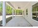 Covered patio features ceiling fan, offering a space for outdoor dining and relaxing with a view of the surrounding trees at 2749 Porches Ln, Dacula, GA 30019