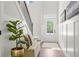 Bright entryway with white walls, hardwood floors, a bench, and a front door with glass panes at 2749 Porches Ln, Dacula, GA 30019